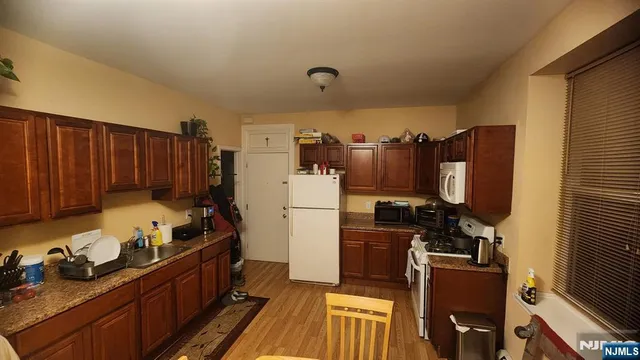 a kitchen with refrigerator and cabinets
