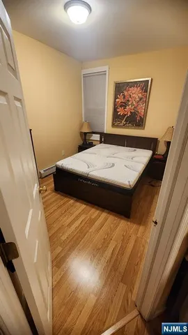 a bed sitting in a bedroom next to a window