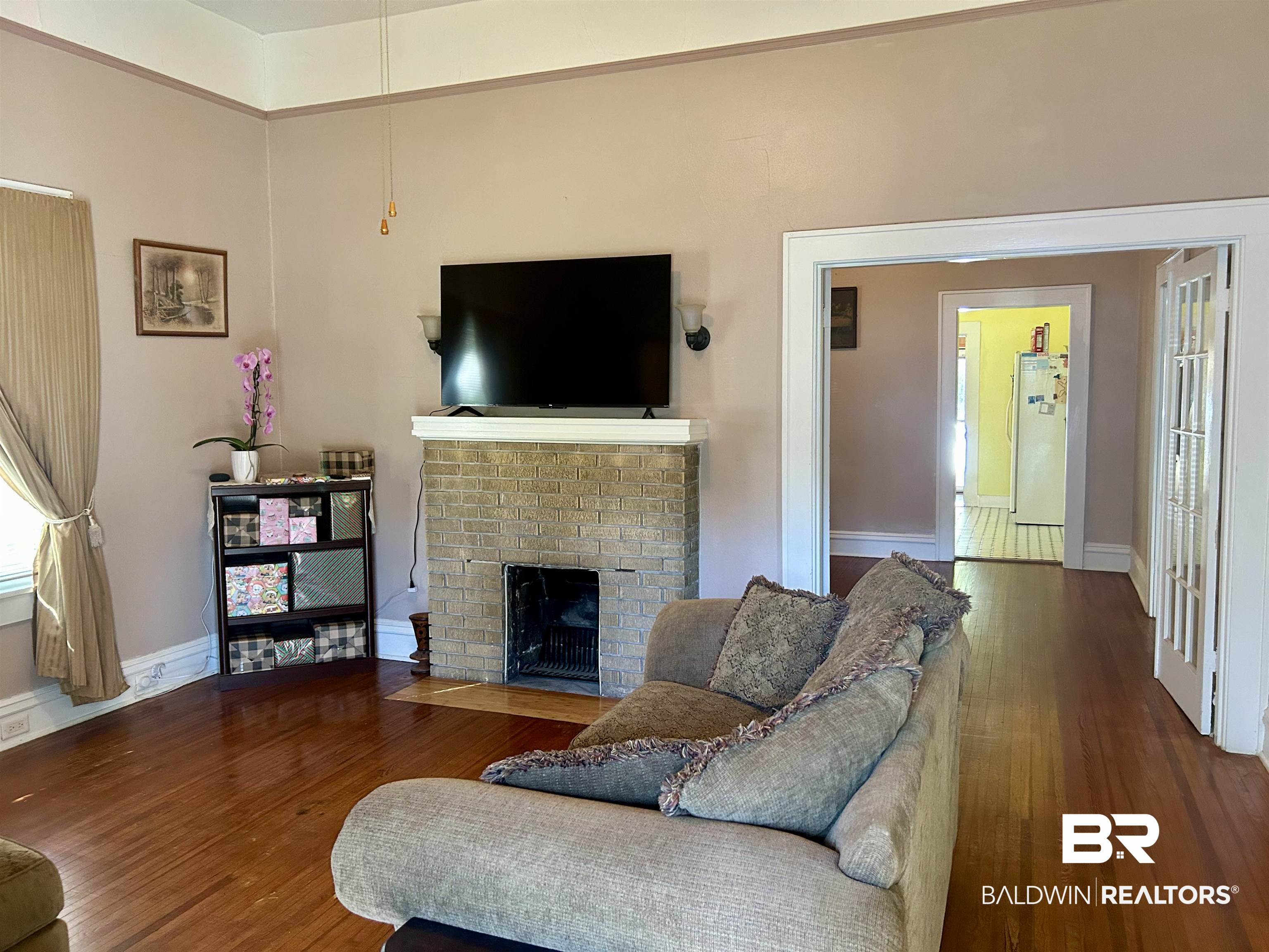 405 North Wasson Avenue Mobile, AL 36612 - Photo 2 of 26 Living room with dark hardwood floors and a brick fireplace