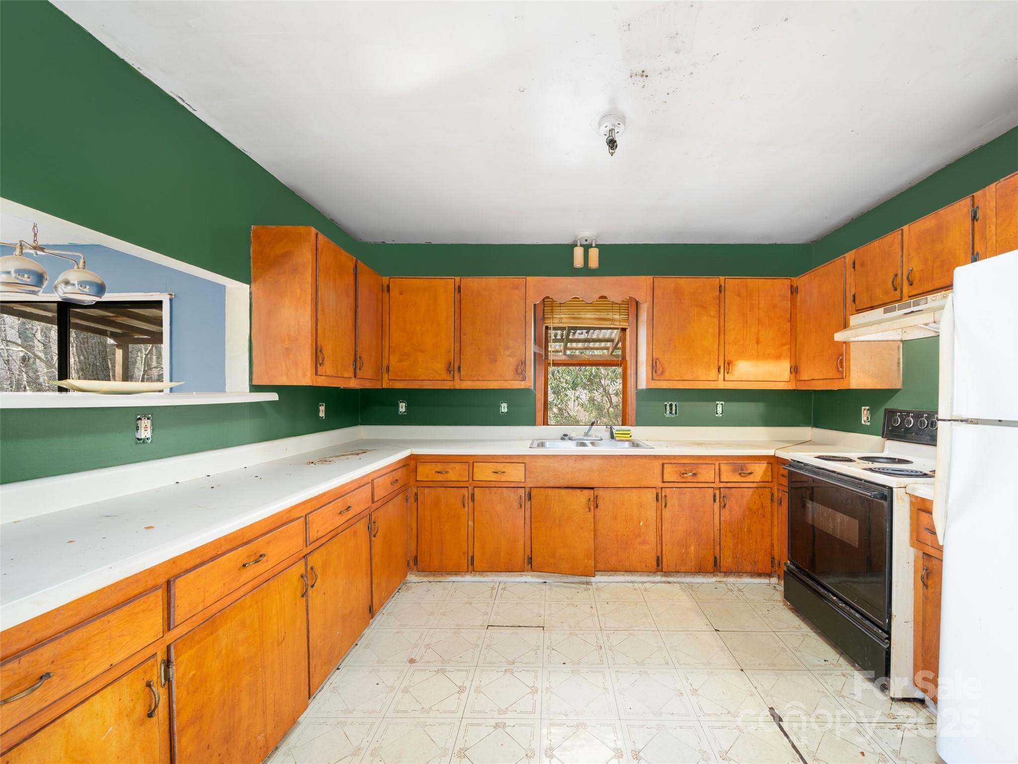 74 George Street Spruce Pine, NC 28777 - Photo 11 of 29 a large kitchen with stainless steel appliances granite countertop a sink and a large window