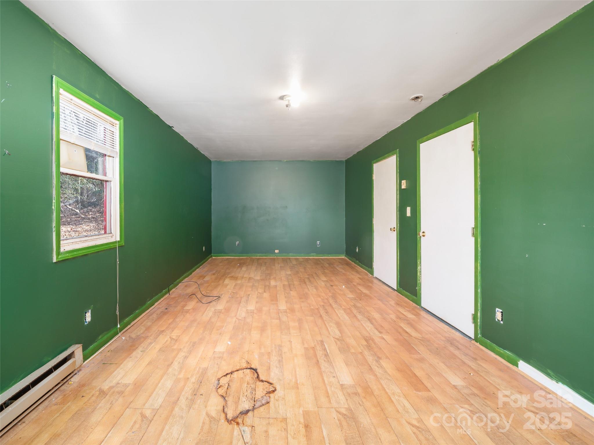 74 George Street Spruce Pine, NC 28777 - Photo 12 of 29 a bedroom with a bed and a window