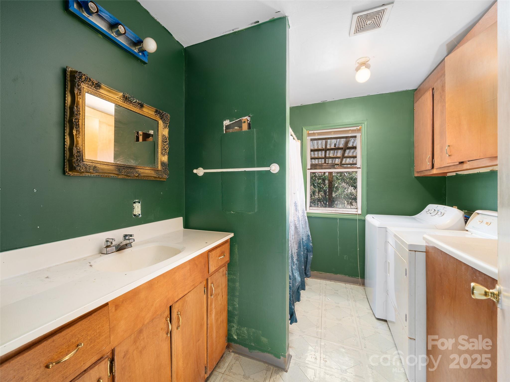 74 George Street Spruce Pine, NC 28777 - Photo 14 of 29 a utility room with a sink washer and dryer