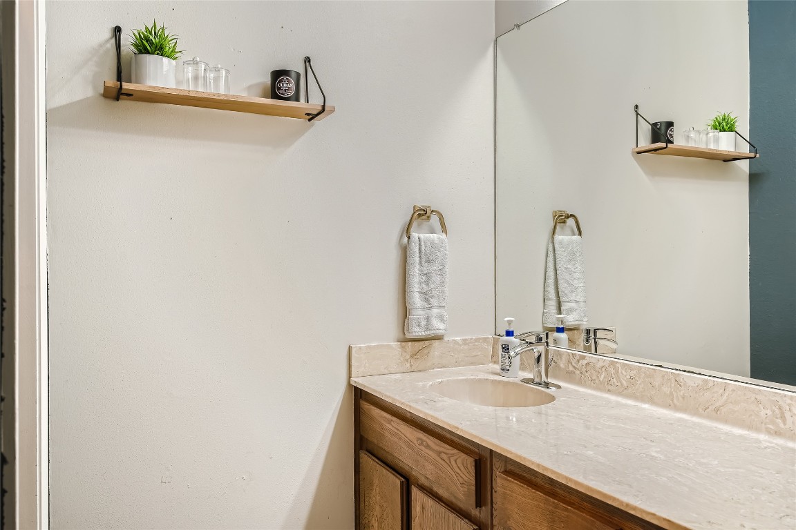 3815 Menchaca Road, Unit 9A Austin, TX 78704 - Photo 12 of 19 a bathroom with a sink and a mirror
