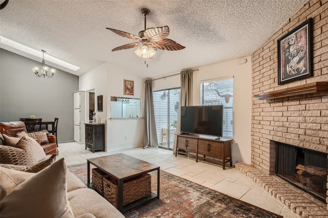 3815 Menchaca Road, Unit 9A Austin, TX 78704 - Photo 4 of 19 a living room with furniture a flat screen tv and a fireplace