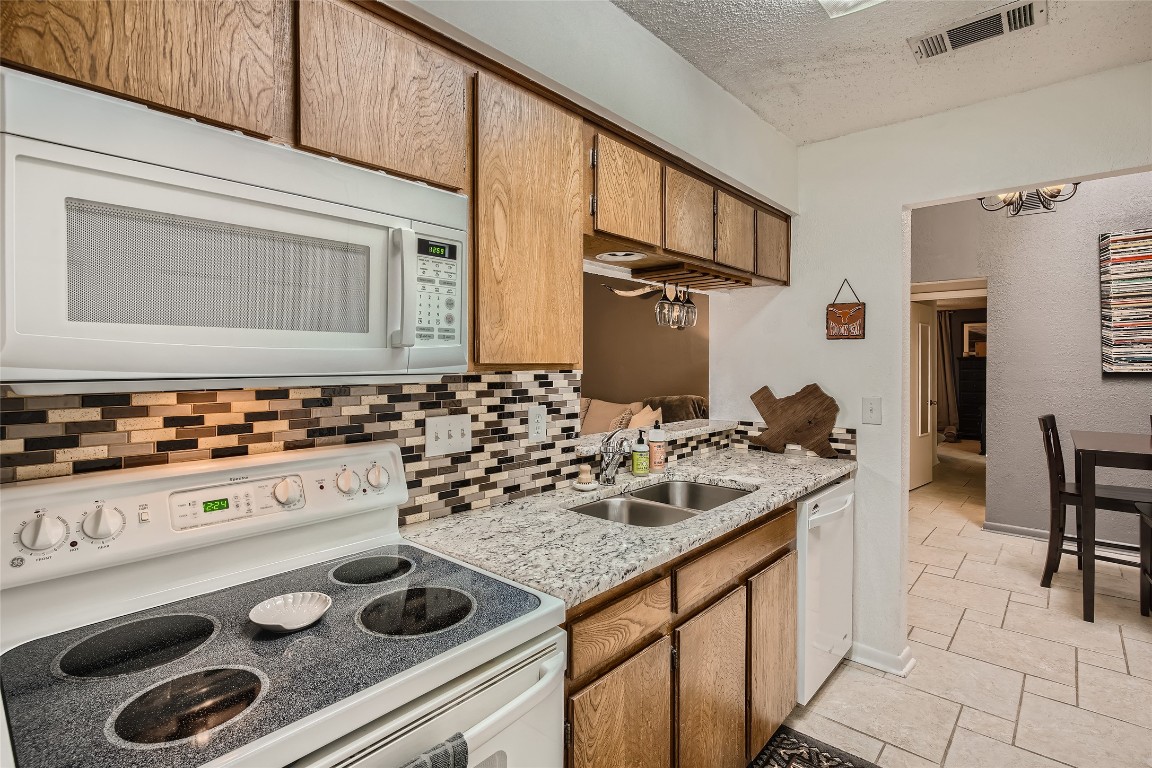3815 Menchaca Road, Unit 9A Austin, TX 78704 - Photo 7 of 19 a kitchen with a stove and a sink