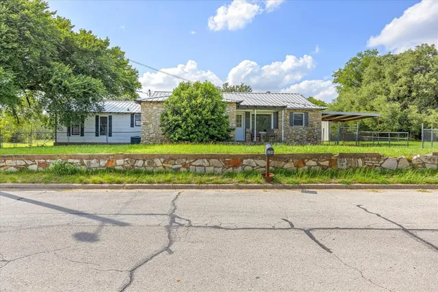 a front view of a house with a yard and a garage