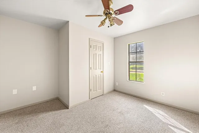 an empty room with windows and closet