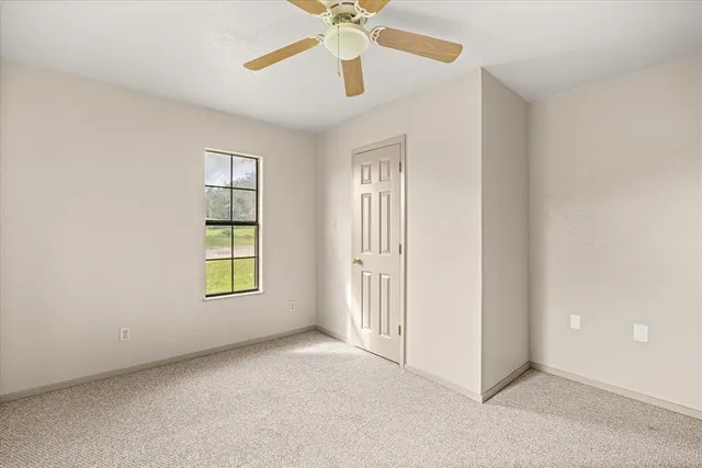 an empty room with windows and closet