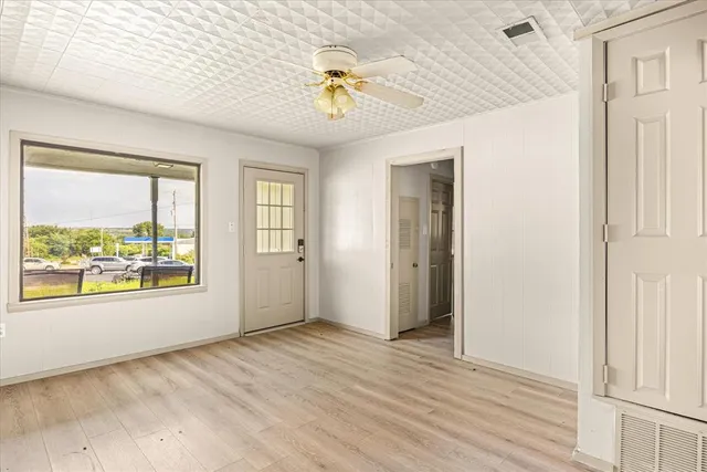 wooden floor in an empty room with a window