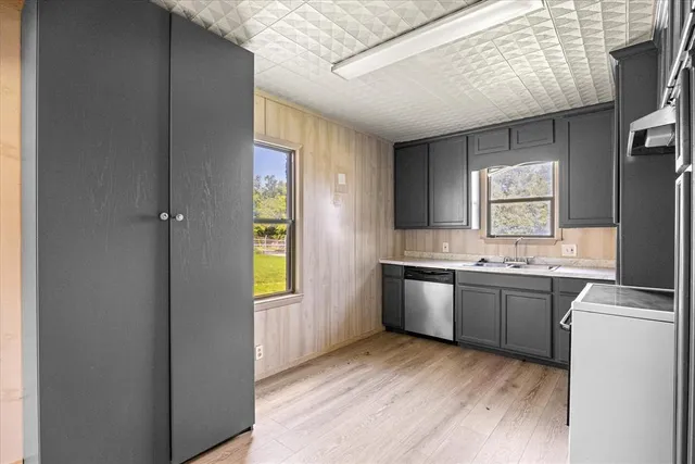 a kitchen with stainless steel appliances granite countertop a refrigerator and a sink