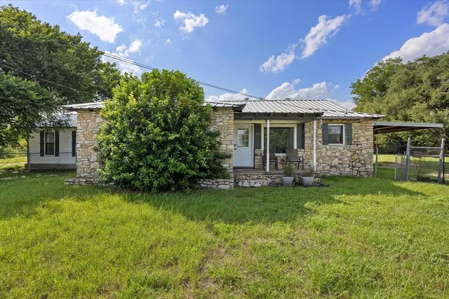a view of a house with a yard porch and sitting area
