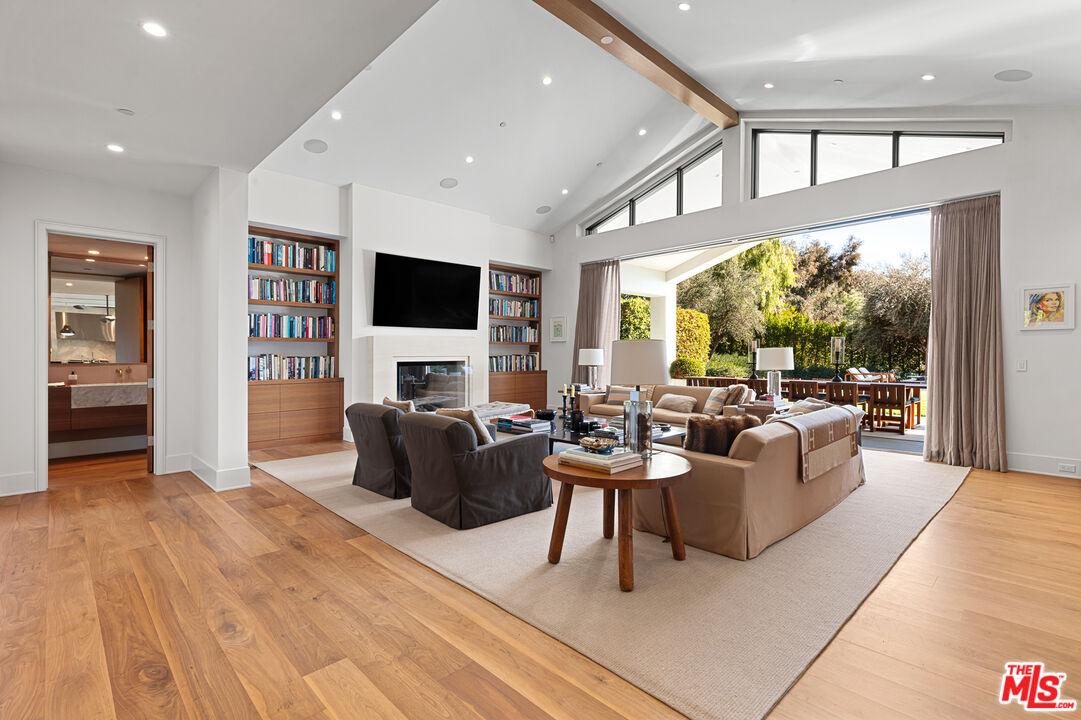 25210 Jim Bridger Road Hidden Hills, CA 91302 - Photo 17 of 65 a living room with fireplace furniture and a flat screen tv
