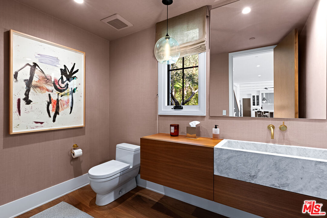 25210 Jim Bridger Road Hidden Hills, CA 91302 - Photo 22 of 65 a bathroom with a sink and a mirror