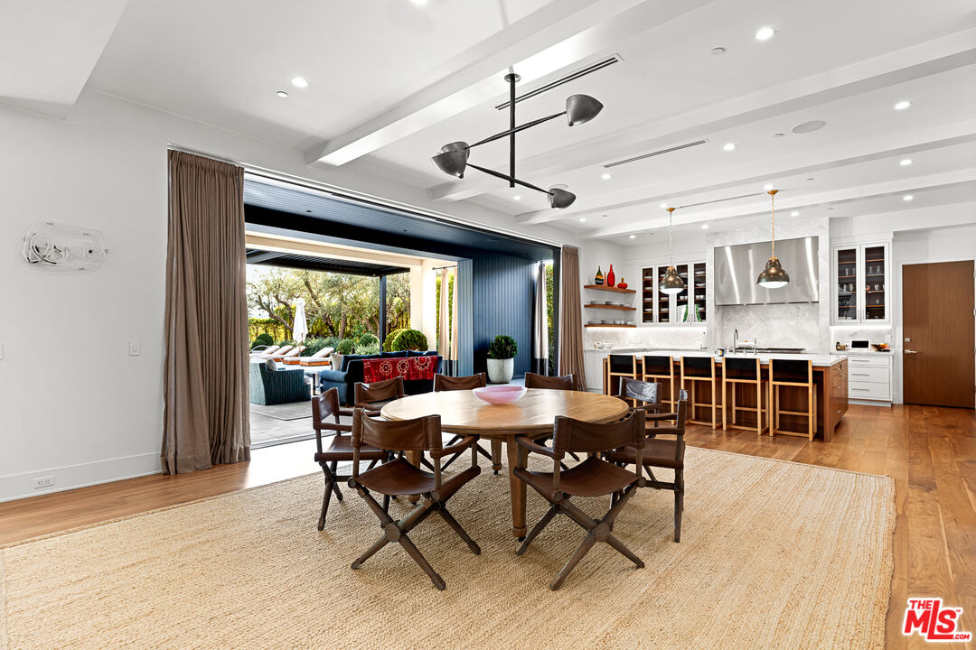 25210 Jim Bridger Road Hidden Hills, CA 91302 - Photo 23 of 65 a dining room with furniture window and wooden floor