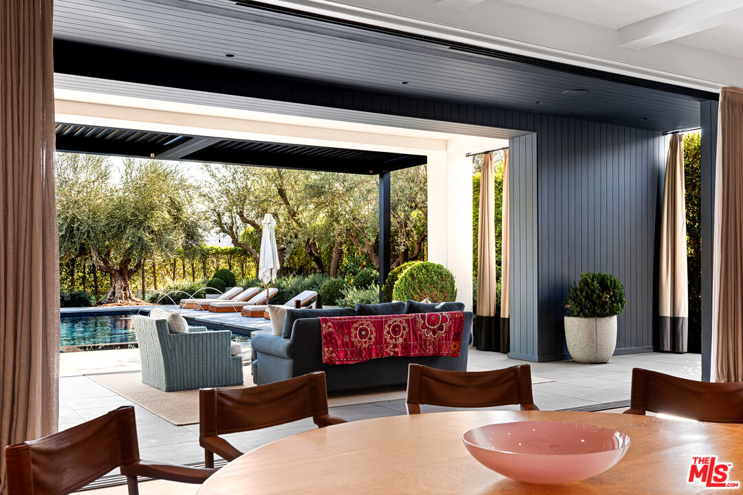 25210 Jim Bridger Road Hidden Hills, CA 91302 - Photo 24 of 65 a living room with furniture and a potted plant