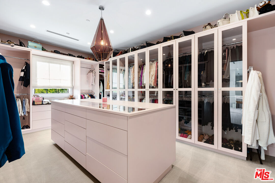 25210 Jim Bridger Road Hidden Hills, CA 91302 - Photo 37 of 65 a kitchen with granite countertop a sink appliances a counter top space and windows