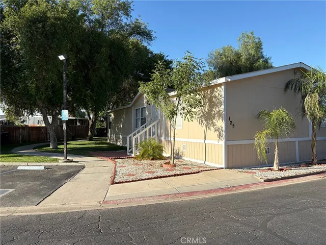 a view of street along with house and trees
