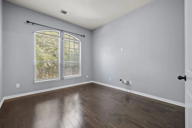 a spacious bathroom with a tub sink and mirror