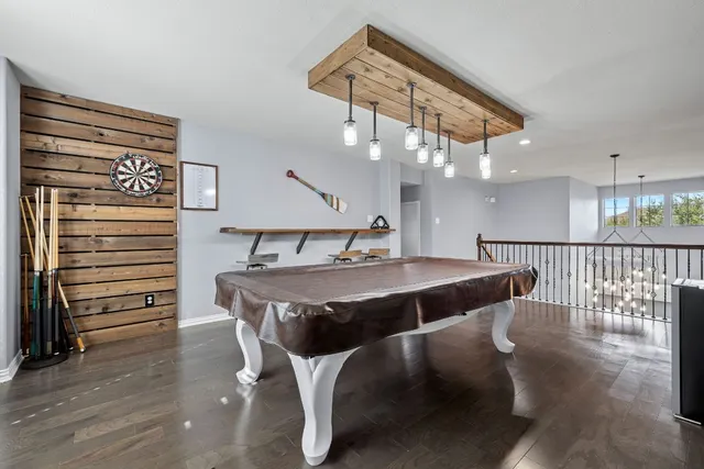 a bathroom with a granite countertop sink a mirror a bathtub and shower