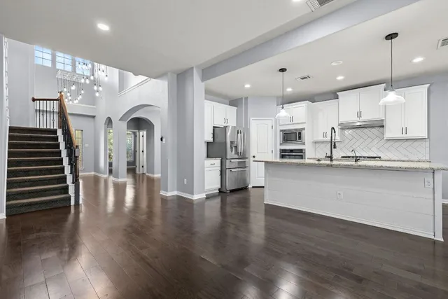 a kitchen with window cabinets and outdoor view