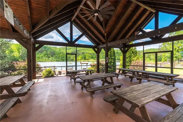 a living room with furniture and floor to ceiling windows