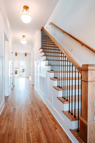 a view of a hallway with wooden floor