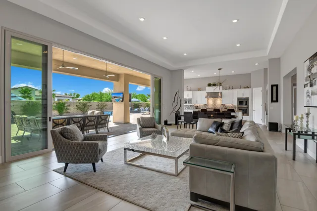 a living room with furniture and view of kitchen