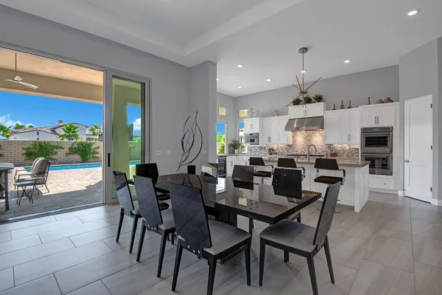 a kitchen with stainless steel appliances kitchen island granite countertop a refrigerator and a stove top oven