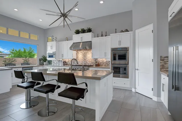 a kitchen with stainless steel appliances granite countertop a sink and cabinets