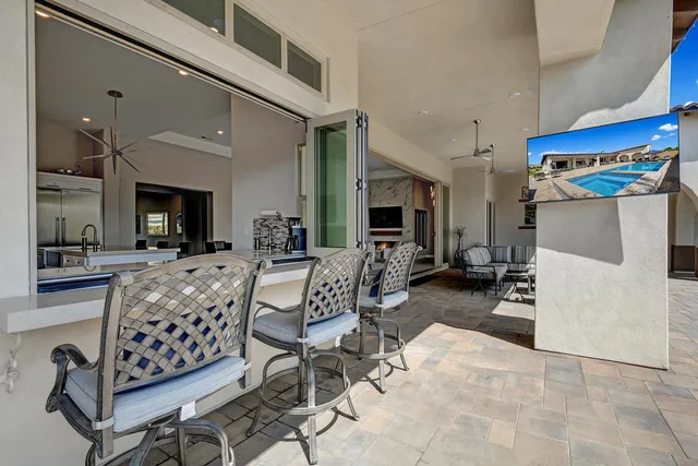 a living room with furniture a rug and a chandelier