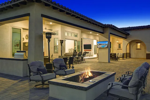 a living room with patio furniture and a large window