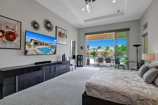 a spacious bedroom with a large bed and a balcony