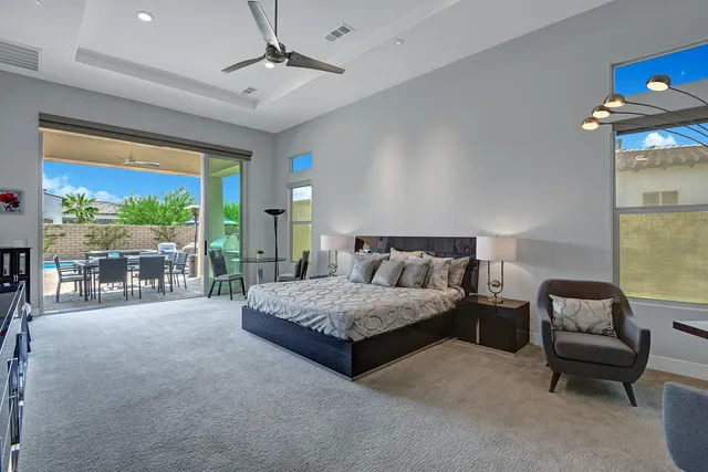 a spacious bedroom with a bed and a table in it