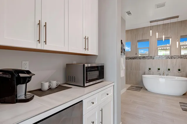 a spacious bathroom with a double vanity sink a mirror and a bathtub