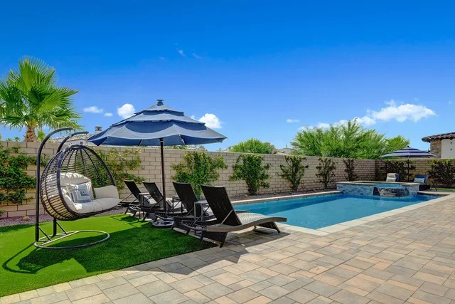 a dining area with furniture and a potted plant