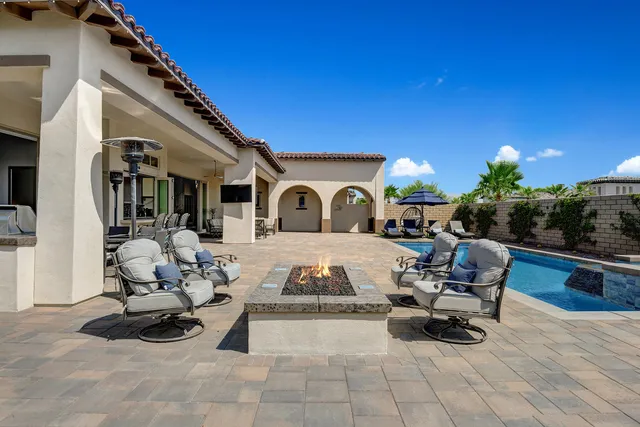 a swimming pool with outdoor seating and yard