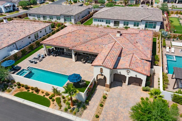 an aerial view of a house with a yard and potted plants