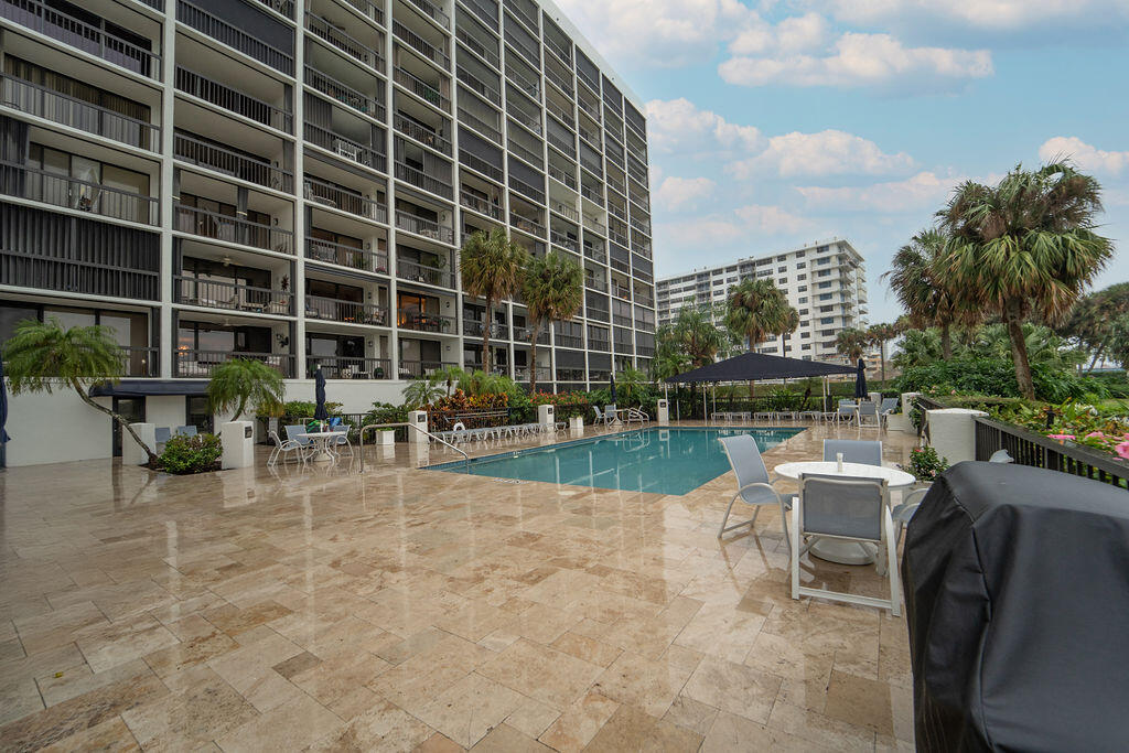 356 Golfview Road, Unit 505 North Palm Beach, FL 33408 - Photo 21 of 30 a view of a swimming pool with outdoor seating and plants