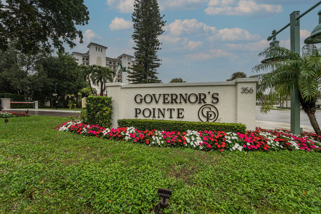 356 Golfview Road, Unit 505 North Palm Beach, FL 33408 - Photo 27 of 30 a street sign that is in front of flowers