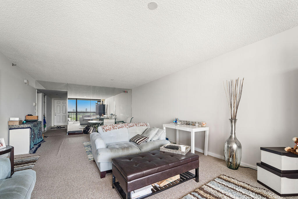 356 Golfview Road, Unit 505 North Palm Beach, FL 33408 - Photo 4 of 30 a living room with furniture and a view of kitchen
