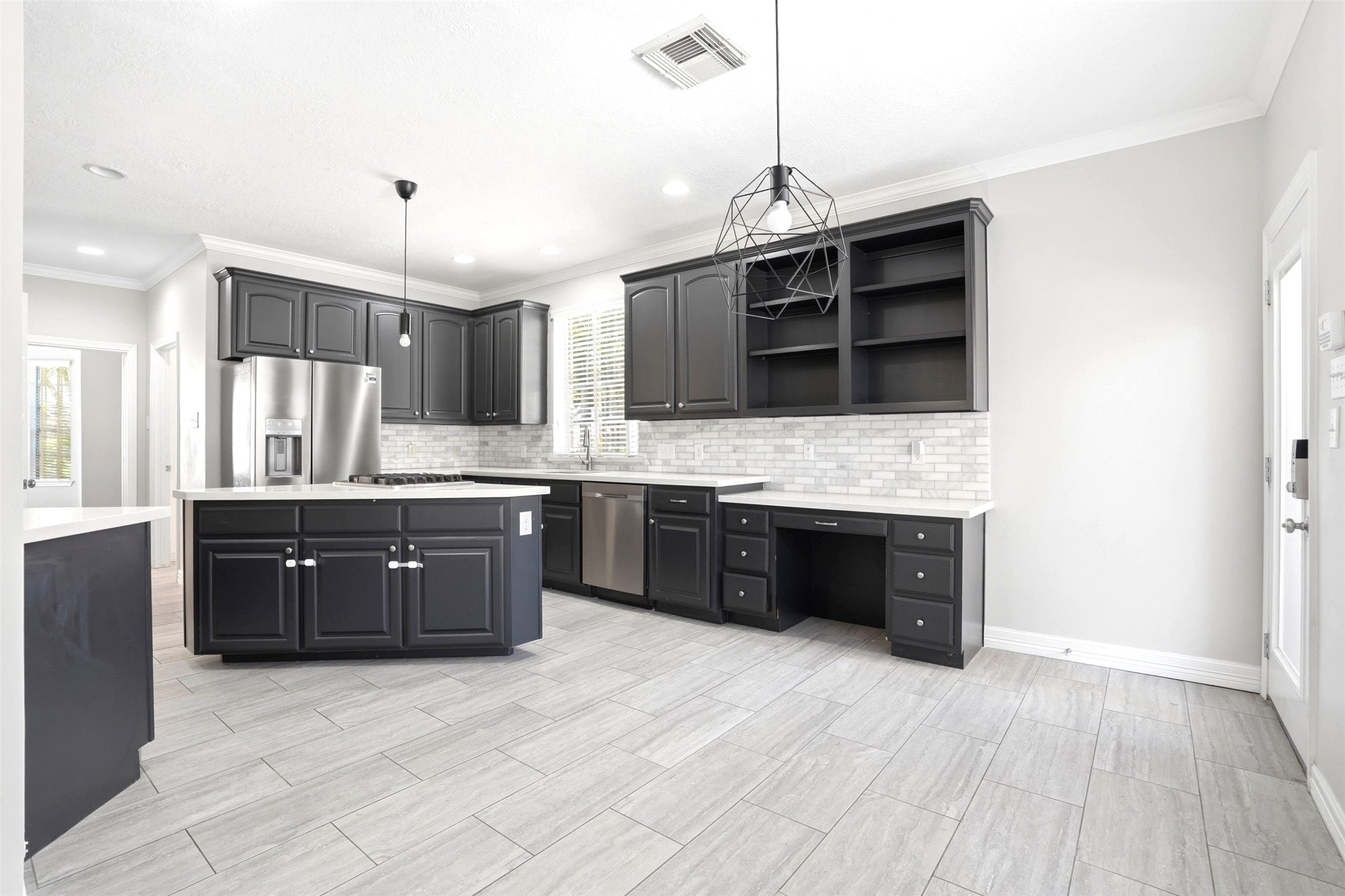 4707 Stackstone Lane Katy, TX 77450 - Photo 15 of 50 a large kitchen with a sink and a stove top oven with wooden floor