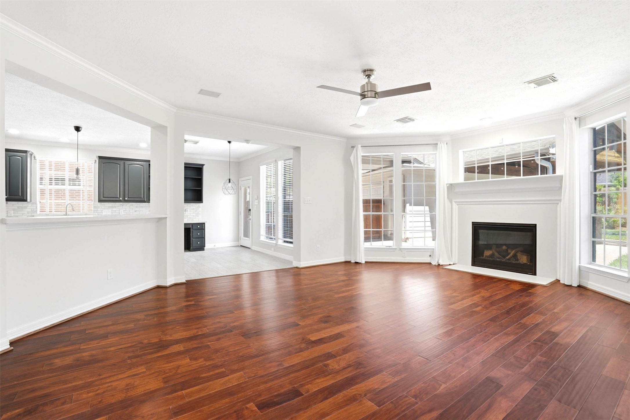 4707 Stackstone Lane Katy, TX 77450 - Photo 18 of 50 a view of an empty room with wooden floor and a fireplace