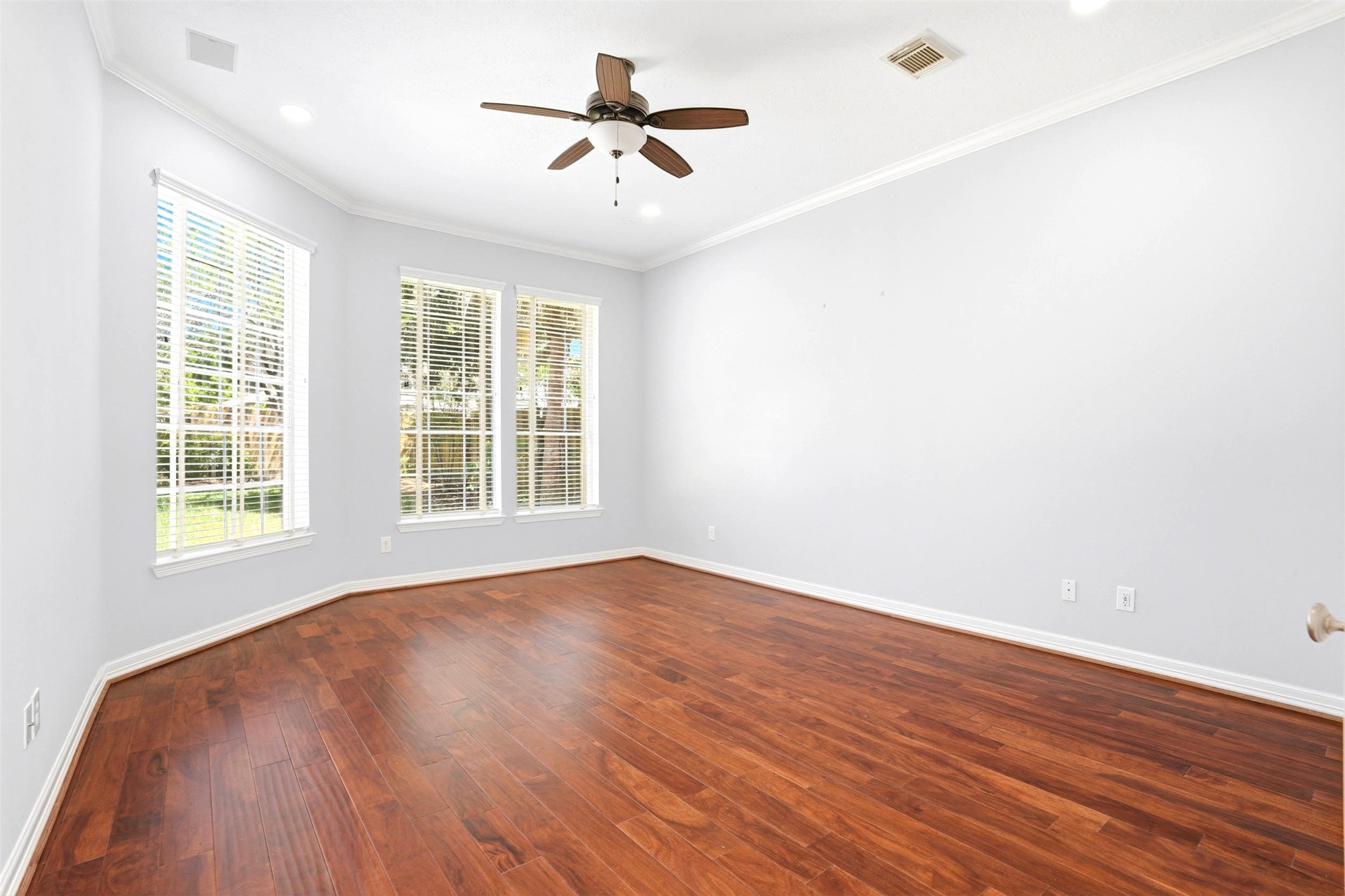 4707 Stackstone Lane Katy, TX 77450 - Photo 23 of 50 an empty room with wooden floor ceiling fan and windows