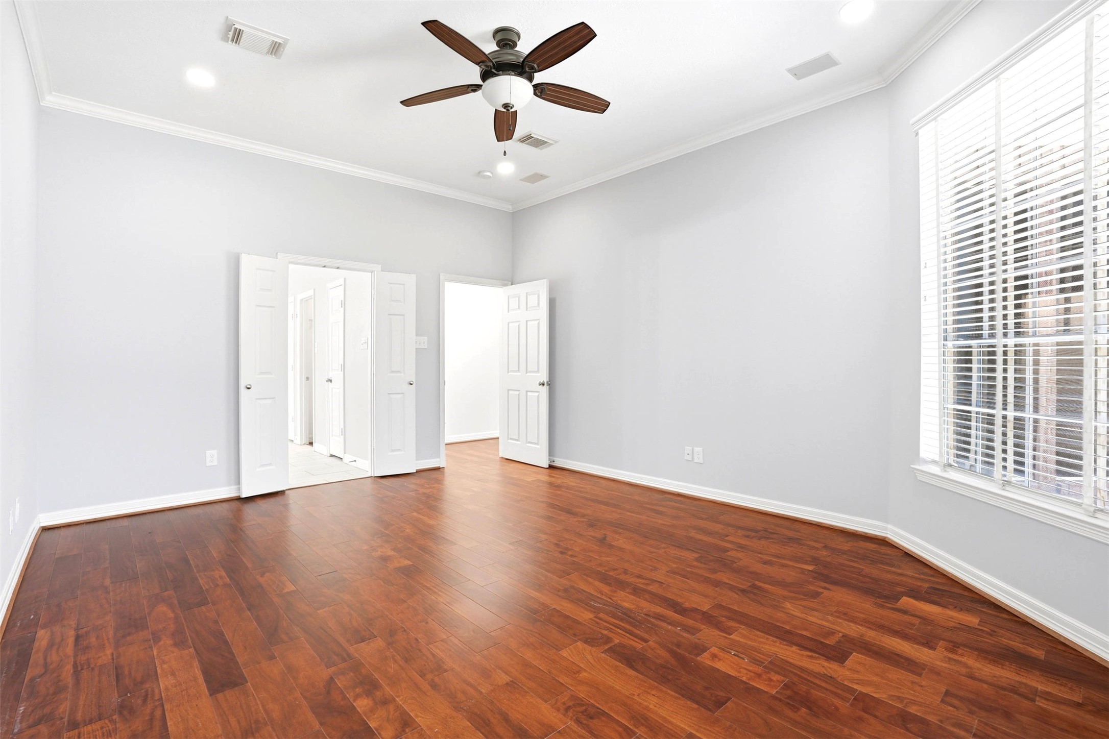 4707 Stackstone Lane Katy, TX 77450 - Photo 24 of 50 an empty room with wooden floor fan and windows
