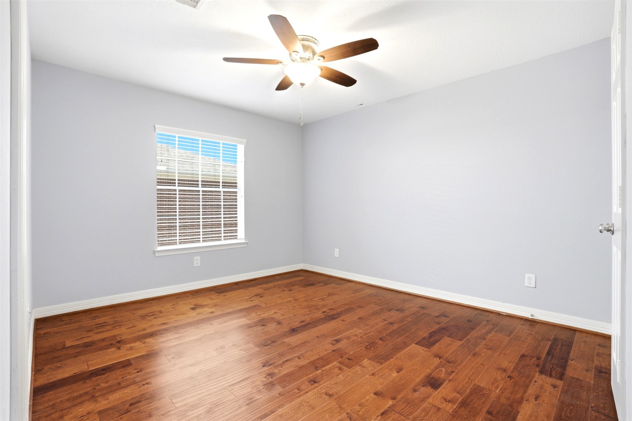 4707 Stackstone Lane Katy, TX 77450 - Photo 29 of 50 an empty room with wooden floor and windows
