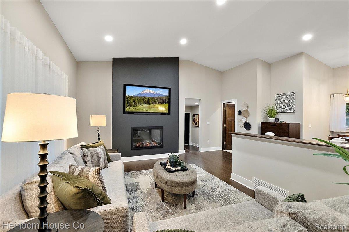 49001 Hanford Road Canton, MI 48187 - Photo 81 of 98 Spacious living area featuring a dark accent wall with a built-in fireplace and integrated television