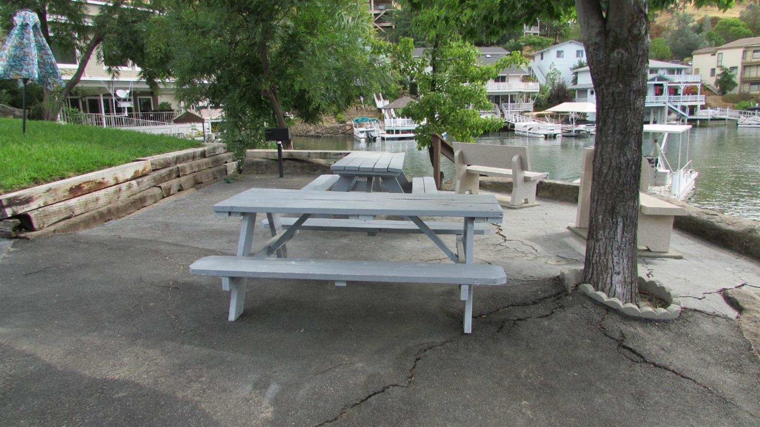 271 Duchess Drive Copperopolis, CA 95228 - Photo 23 of 34 a view of a patio with table and chairs potted plants and a fountain