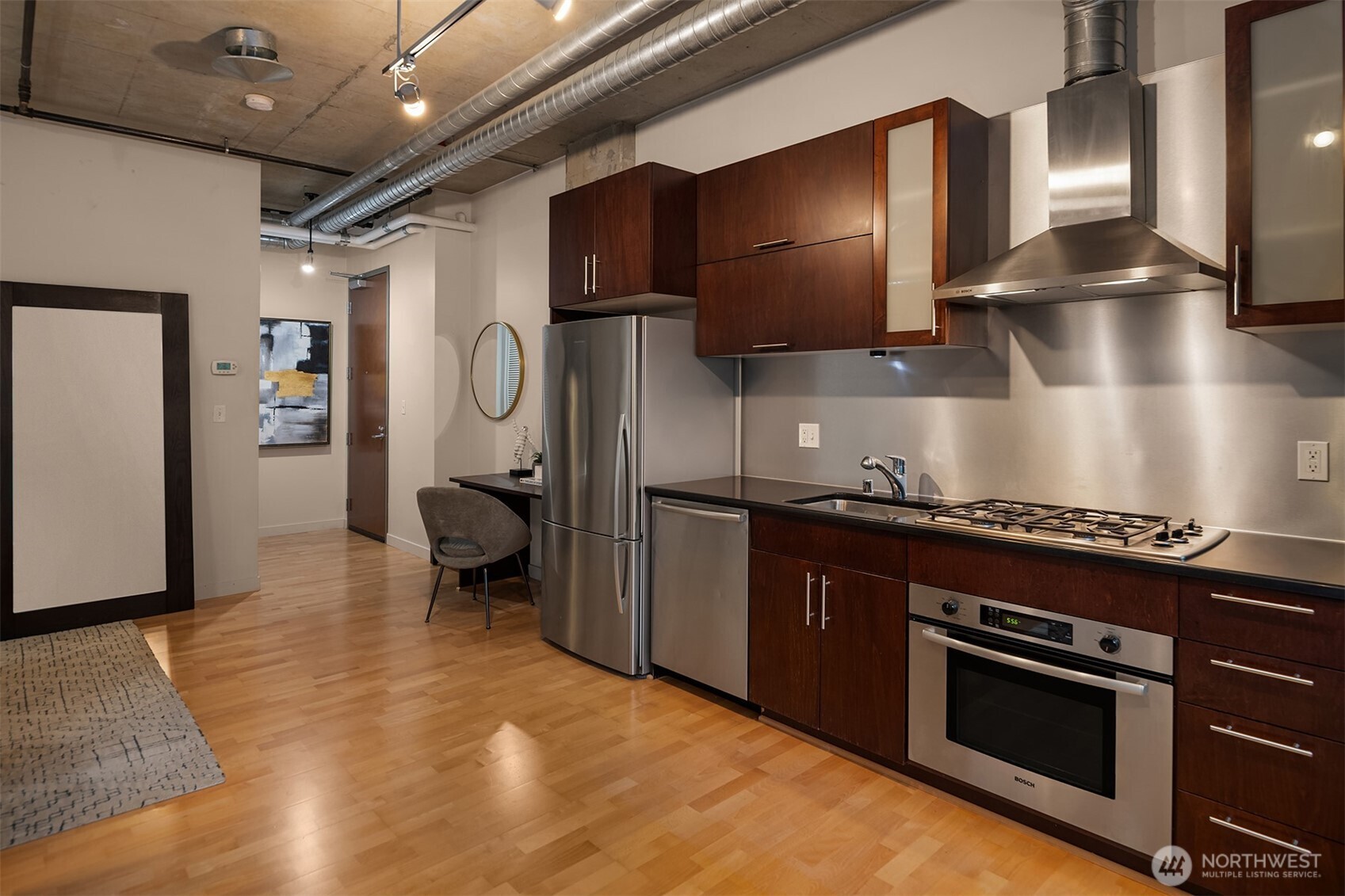 2720 3rd Avenue, Unit 505 Seattle, WA 98121 - Photo 4 of 25 a kitchen with granite countertop a stove and a refrigerator
