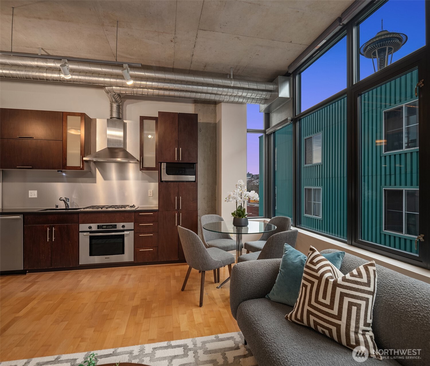 2720 3rd Avenue, Unit 505 Seattle, WA 98121 - Photo 5 of 25 a kitchen with stainless steel appliances granite countertop a stove top oven a sink and a dishwasher