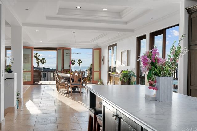 a kitchen with kitchen island a stove a refrigerator and a sink